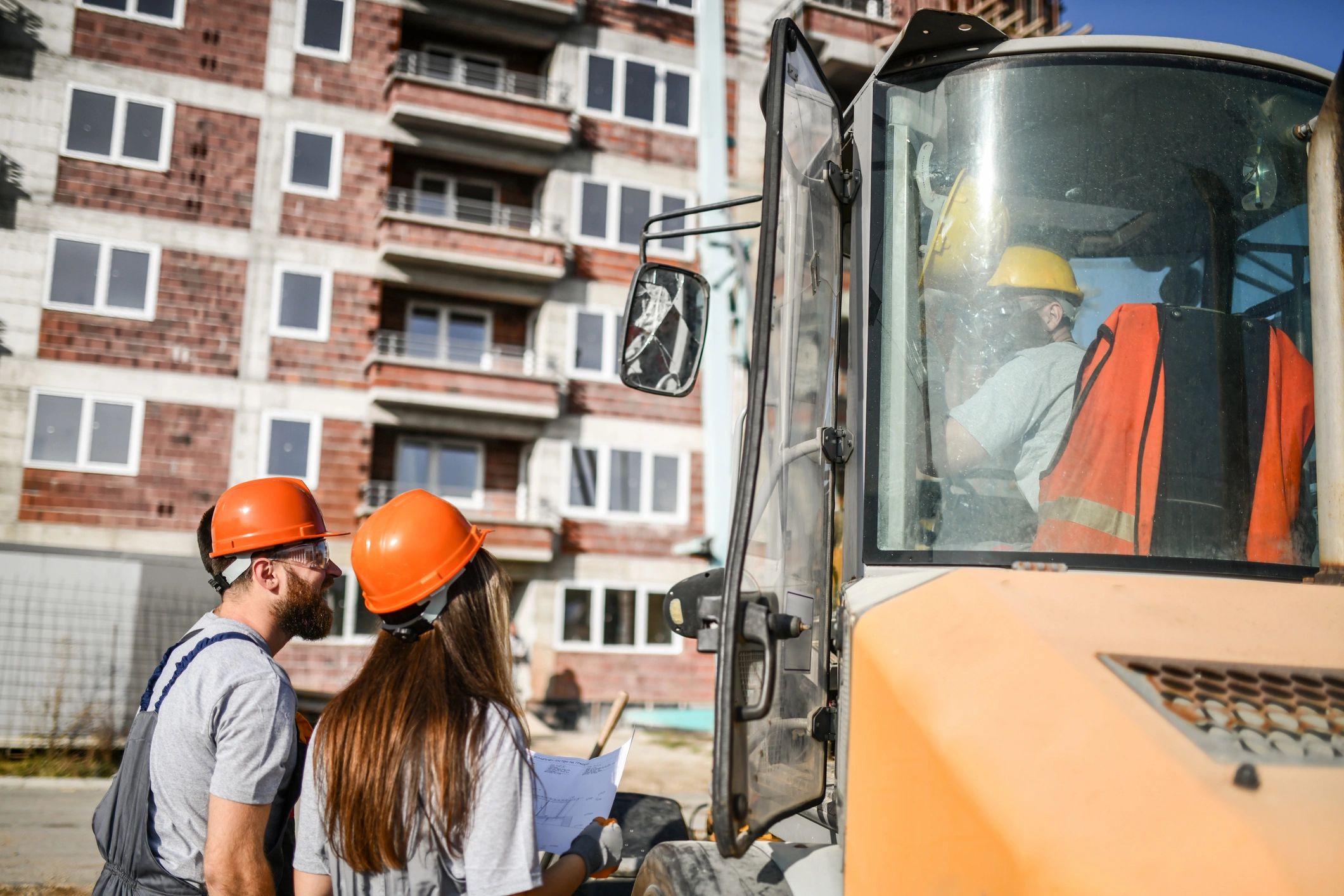 Construction professionals coordinating work on site